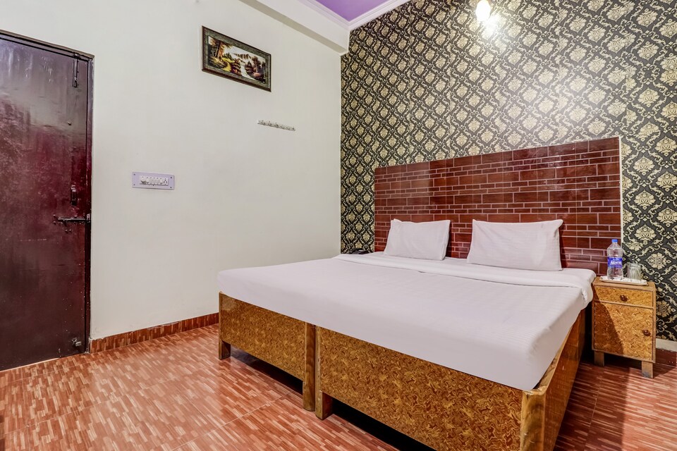 AC double bed room with patterned headboard
