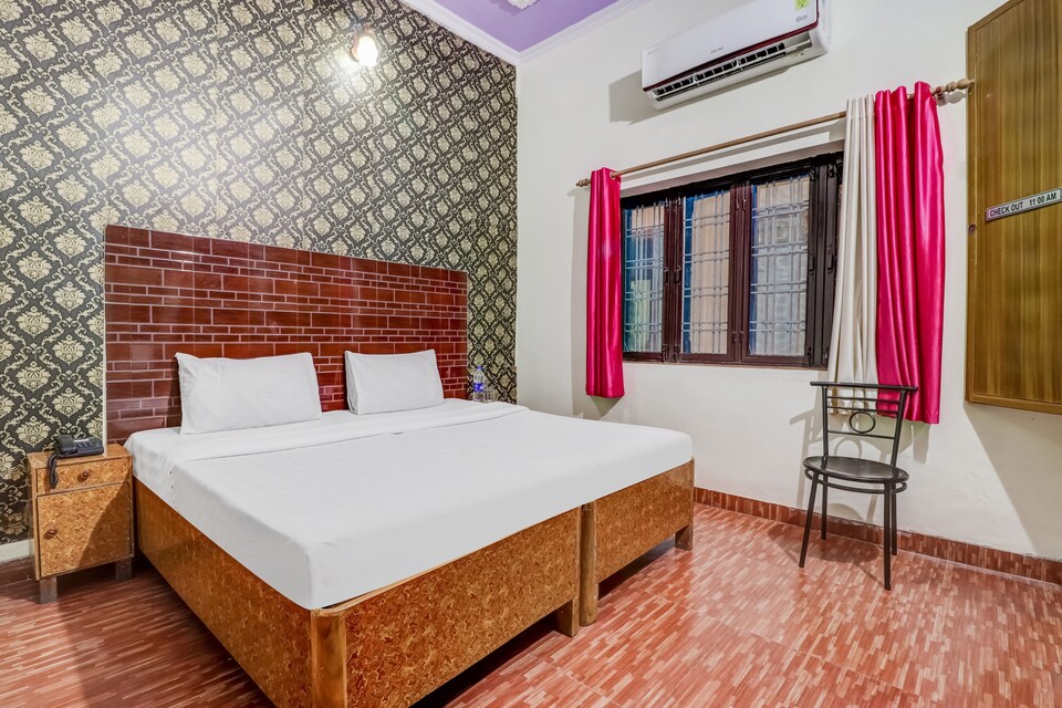 Comfortable guest room with AC and red curtains